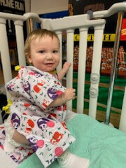Hayden smiling in a crib