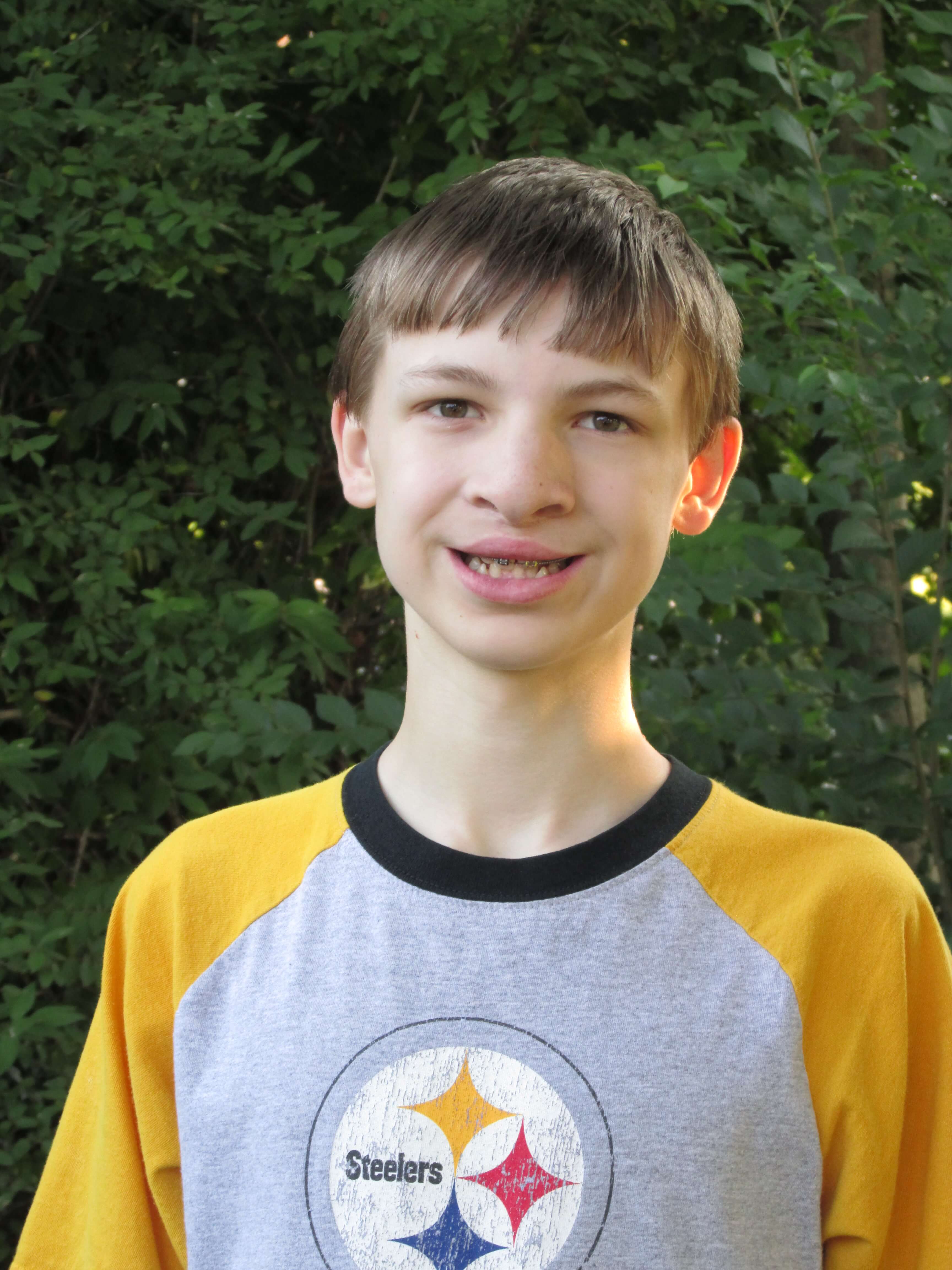 Ryan as a child, after undergoing surgery for cleft lip. He is wearing a Steelers t-shirt.