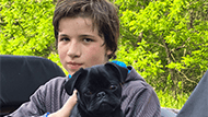 Luke holding a black pug