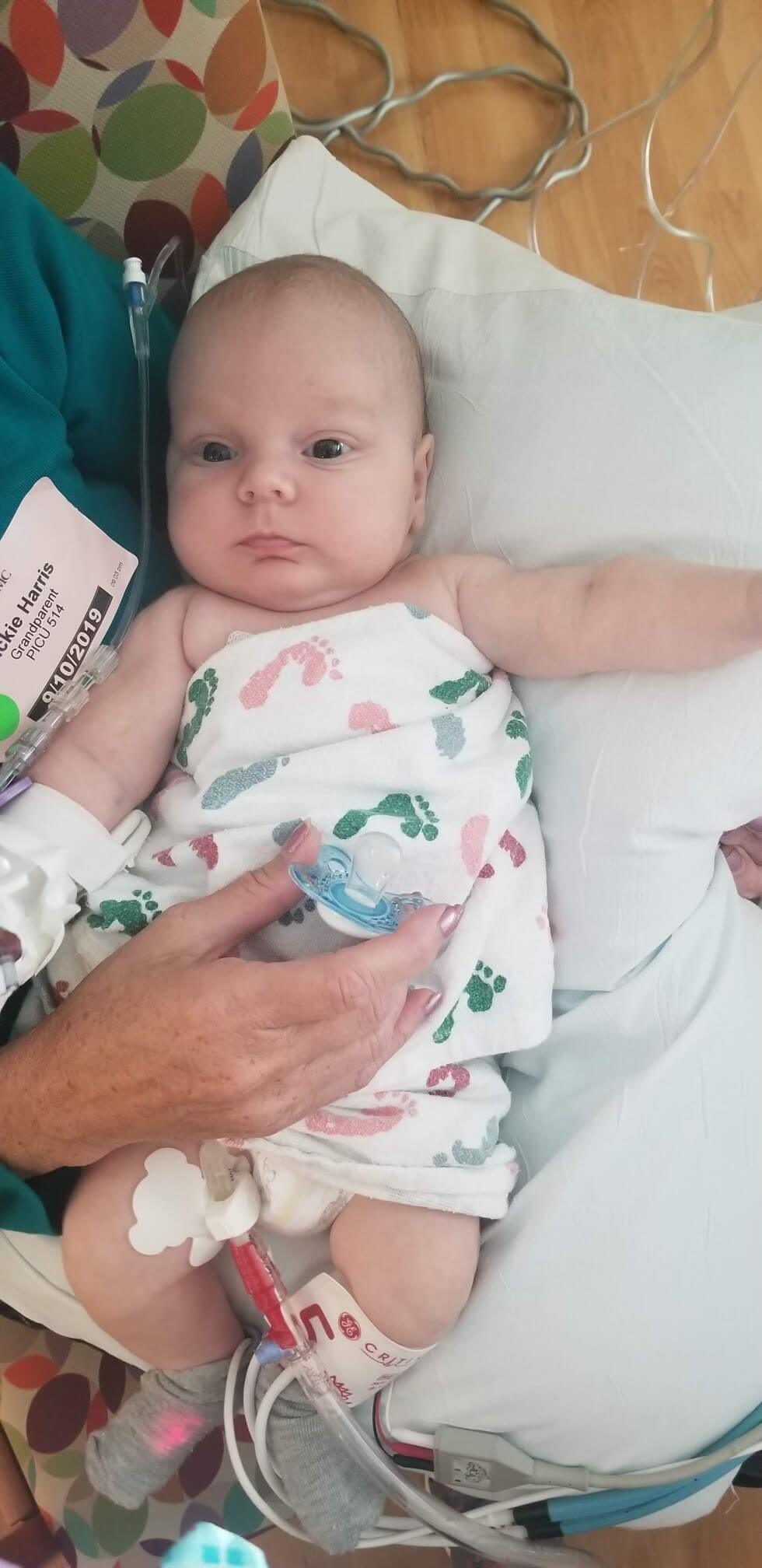 Jaxson Harris as a baby in a onesie