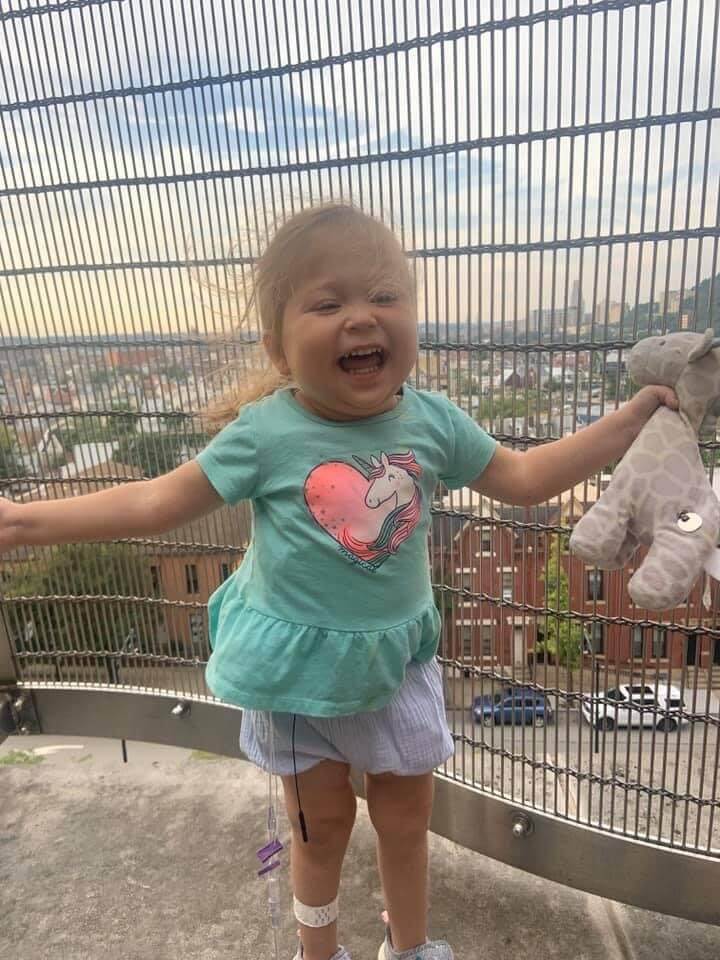 Liliana laughing in a blue shirt