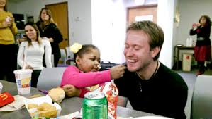 Jamie Folmar feeds french fries to David Denovchek, her liver transplant donor.