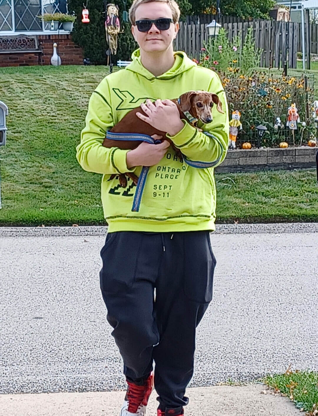 John Richardson walking with his puppy in his arms