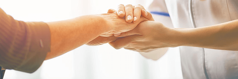 Image of provider holding patient's hand.