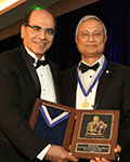 AAPM President Dr. Ehsan Samei presents the William D. Coolidge Award to Dr. Saiful Huq.