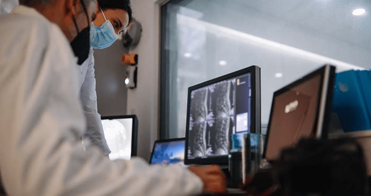 physicians looking at spine scan
