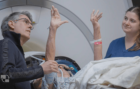 Jorge González-Martínez, MD, PhD, and Theodora Constantine, senior physician assistant, assess a patient after she’s received focused ultrasound treatments for essential tremor.