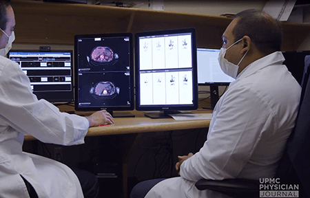 Image of doctors looking at screen.
