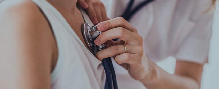 photo of doctor listening to child's heart with stethoscope