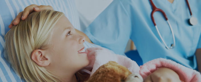photo of little girl in hospital bed with doctor or nurse at her bedside