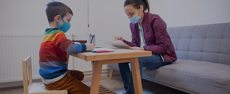 Child and adult sitting at a table