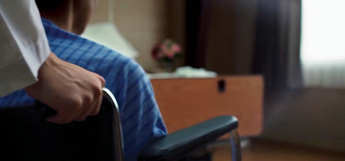 Someone pushing a man in a wheelchair. UPMC is More Life Changing Than You Know