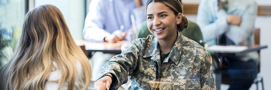 Banner is image of female veteran shaking hands with program coordinator. 