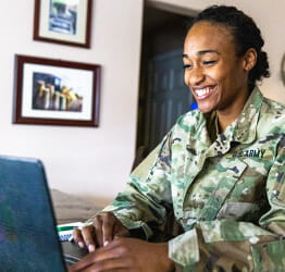 Image of female veteran typing on laptop.