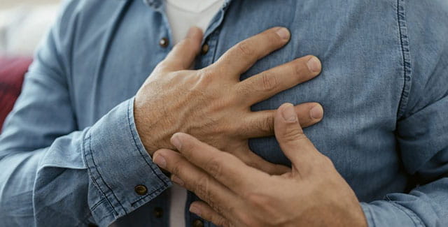 Man with his hands over his heart.