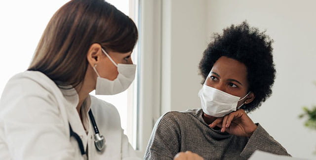Woman talking to her doctor.