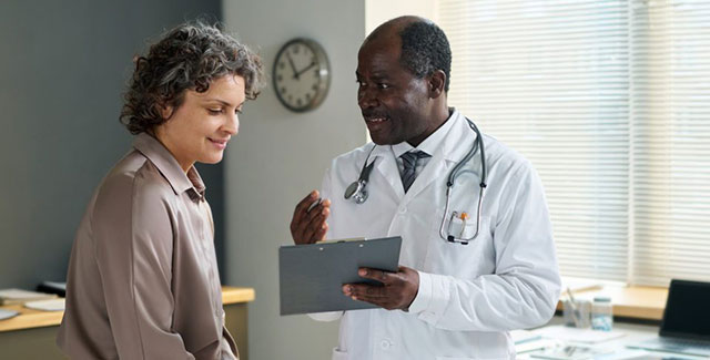 Photo of doctor talking to patient.
