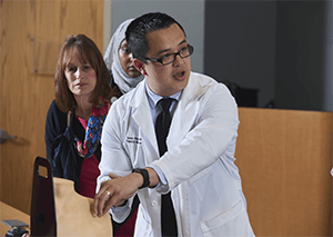 Image of a resident physician explaining the salary and benefits of the family medicine residency program. 