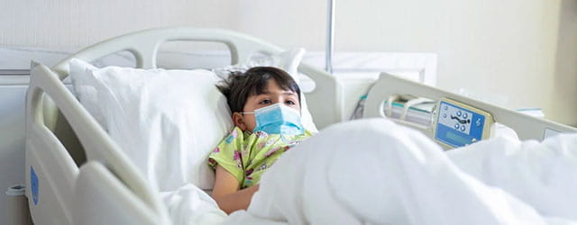 Patient in hospital bed.