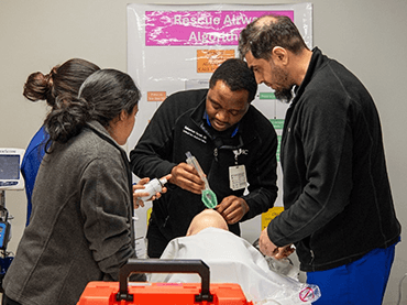 Image of students working with dummy.