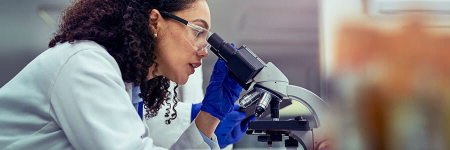 Histology banner. Image of provider looking in microscope.