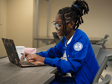 Image of student working on laptop.