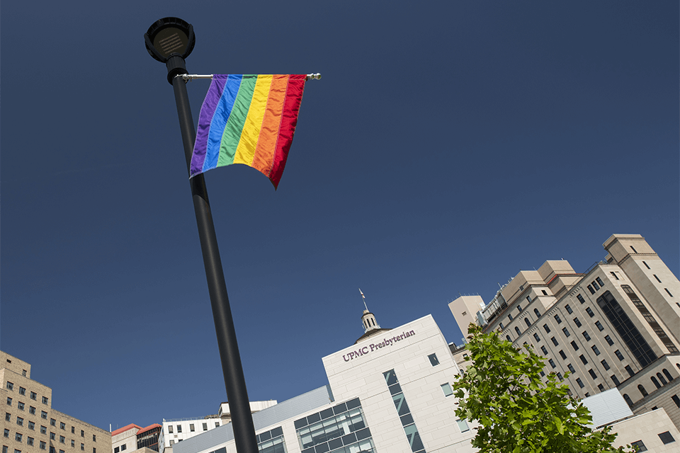 Pride Health Sign: a pride flag hanging outside UPMC Presbyterian.