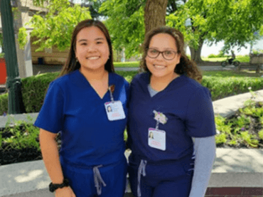 Image of students posing outside in scrubs.