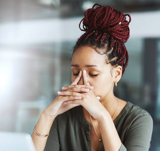 Image of a woman experiencing stress.