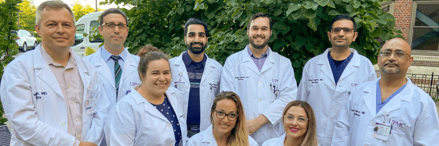 A group photo of nine UPMC Neurology residents. They all wear lab coats. 