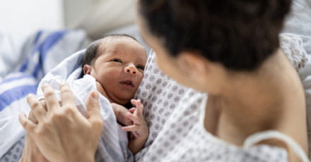 Mother holding baby after birth