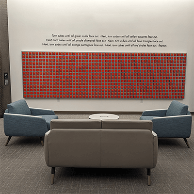 This photo was taken on the first day of the installation after the artist added in all 700 cubes, placing them all so the red side was facing out.