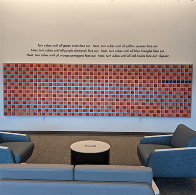 People immediately began engaging with the artwork. This photo was taken the day after the installation was complete, showing the cubes turned to display many different colors.