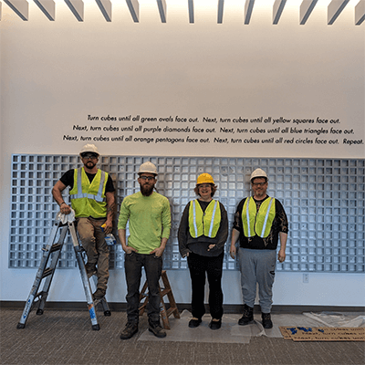 To create the project, the artist assembled the cubes in her studio in Maine. She hired Technique Architectural Products to fabricate and install the aluminum structure to hold the cubes in the wall. 