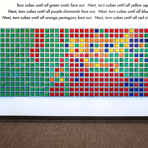 Artwork of custom-designed cubes that light based on public interactions. Learn more about Amy Curtis' art installation.