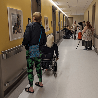 This photo shows people exploring some of the portraits in the clinical corridors.
