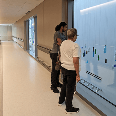 Onlookers view the artwork from the second floor window.