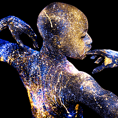Photograph of a person taken with a camera flash that transmits ultraviolet light. Learn more about Nommo Semi, Guardian of Space by Mikael Owunna.