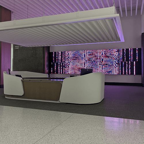 The artist incorporated features of the lobby into the artwork. Vertical LED panels of the piece relate to the ceiling and sound absorbing panel's vertical line design used above the information desk. 