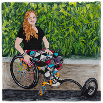 Adrian Luther sits in a wheelchair in front of a leafy green background.