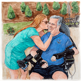 Andy Reese sits in a wheelchair and receives a kiss on the cheek from his wife.