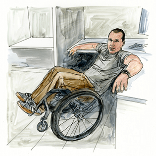 Dan McCoy sits in a wheelchair in front of a green background. 
