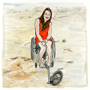 Katie sits on a beach wearing a red dress, smiling in her wheelchair.
