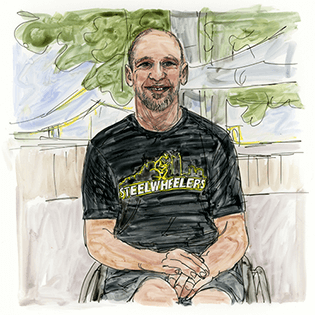 Lee Tempest sits wearing a Pittsburgh Steelwheelers t-shirt in front of a yellow bridge.   