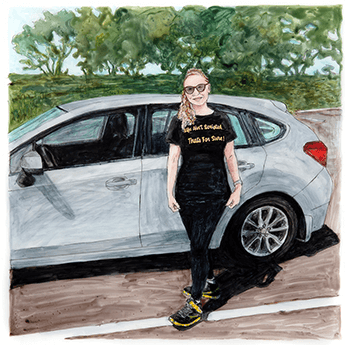 LaTisha Willis stands in front of her grey car.