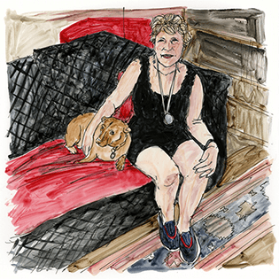 Patty Azocar sits on a black softa with a brown dog. 