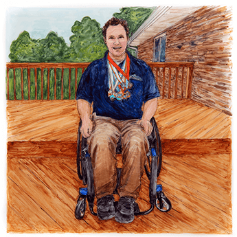 Tom sits outside on a deck in his wheelchair with several medals around his neck. 