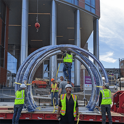 The artist and her installation team in April 2023 standing outside the Mercy Pavilion building.