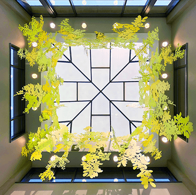 The artwork reinforces the design of the skylight – notice how it looks like branches connected to a tree trunk.  Photo by Carin Mincemoyer.