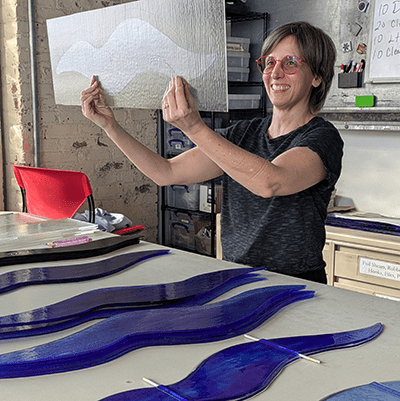 The artist created each glass shape at the Pittsburgh Glass Center, located a few miles away from the hospital.  Each “wave” is made from two pieces of glass fused together in a kiln - one clear, and one color. 